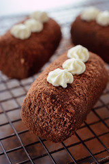 Delicious chocolate brownie as a potato form, Russian traditional dessert, on a pastry lattice, close up