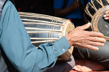 Close up of right hand and traditional drum of drummer in Bhaktapur in Nepal.