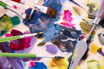 artists palette with paints and brushes