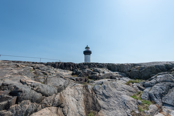 Ursholmen, Sweden - July 26, 2019: View of the lighthouse of the island Ursholmen in the Swedish National Park Kosterhavet in western Sweden.