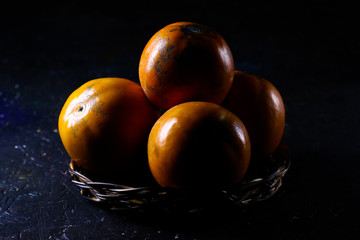 Persimmons. Persimmon fruits in basket.