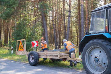 Road repair by a team of professional builders