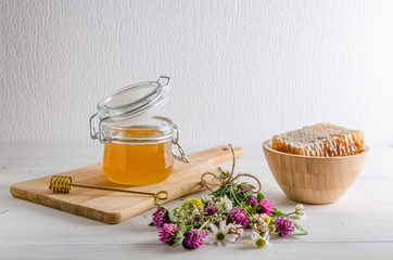 fresh floral honey and honeyt with flowers on a white background