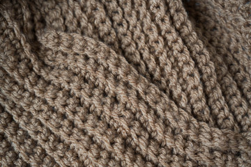 Knitted horizontal textured brown fabric on a white background. Fragment of a brown color sweater. Texture, close up. For yarn, clothing, needlework store, flyer design, banner, for site