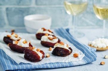 Almond and goat cheese stuffed dates with glasses of wine