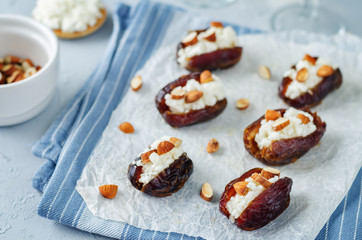 Almond and goat cheese stuffed dates with glasses of wine
