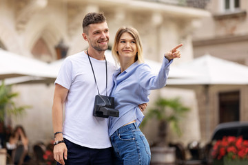 Happy couple of tourist travelers around city with motorbike scooter