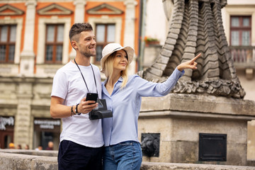 Happy couple of tourist travelers around city with motorbike scooter