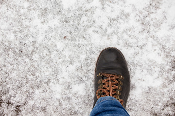 A man steps on the first snow. Man's leg in the snow. Copy space_