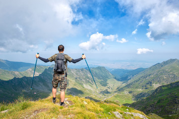 Successful active man hiker on top of mountain enjoying the view. Travel sport lifestyle concept