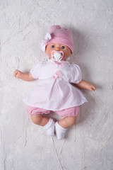 cute baby doll tot with dummy around white background