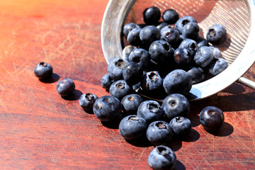Blueberry on wooden table background. Ripe and juicy fresh picked blueberries closeup. 
