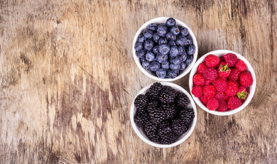 Variety of berries on wooden background. Ripe Organic Blueberry Raspberry Blackberries. Blueberry Raspberry Blackberries copy space