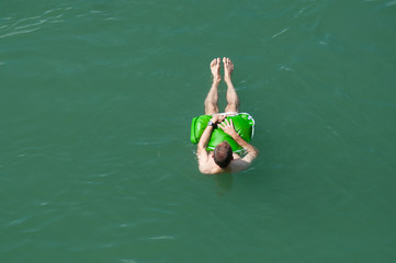 Portrait on top view of man floating in rhine river in Basel Switzerland