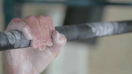 Male hand holding pull ups bar. Man doing pull-ups. fitness equipment.