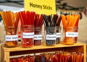 Organic fresh bee honey sticks on display. Farmers market.
