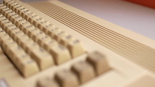 Man hand typing on old computer, slider shot