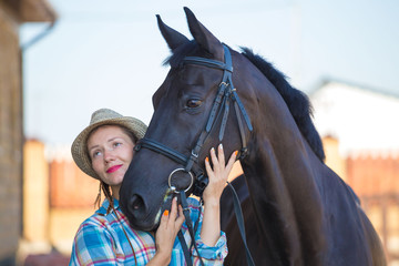 Obraz premium Woman and horse. Close up
