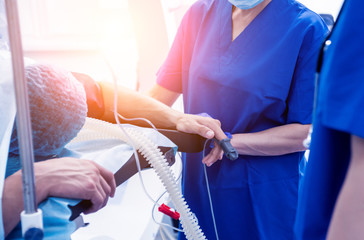 Spinal surgery. Group of surgeons in operating room with surgery equipment. Laminectomy