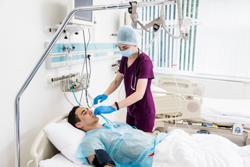 Doctors give resuscitation to a male patient in the emergency room. Cardiac massage
