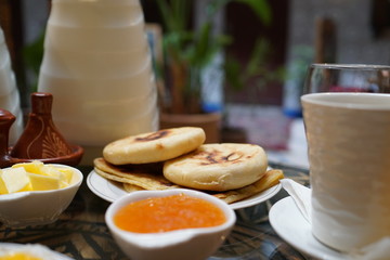 Pancakes with honey and butter for breakfast.