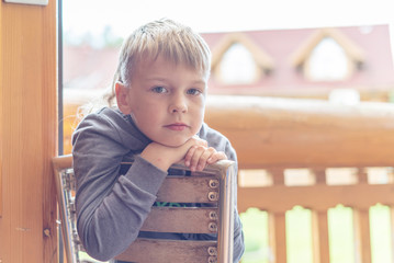 portrait of a brooding boy in sun rays