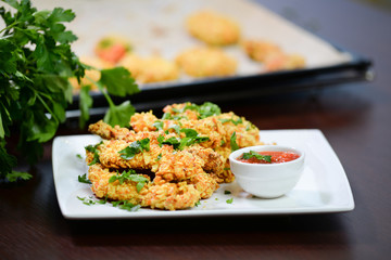 corn flakes breaded deep fried chicken breast sticks on white plate