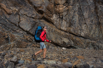 Female traveller walking in front of cliffs