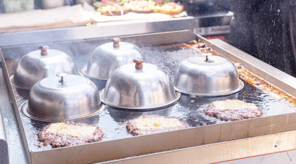 frying meat for burgers on the street
