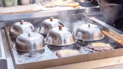 frying meat for burgers on the street