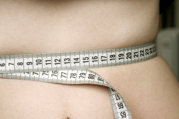 Close up woman measure her waist. Weight loss