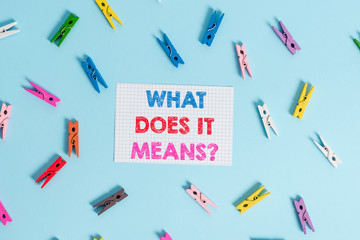 Handwriting text writing What Does It Means question. Conceptual photo asking someone about meaning something said and you do not understand Colored clothespin rectangle shaped reminder paper light