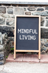 Fototapeta premium Handwriting text writing Mindful Living. Conceptual photo Fully aware and engaged on something Conscious and Sensible Empty black board with copy space for advertising. Blank dark board