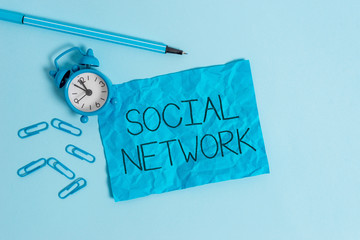 Word writing text Social Network. Business photo showcasing Interactions Sharing Information Interdemonstratingal relationship Metal alarm clock blank crushed sheet marker clips sky colored background