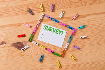 Writing note showing Survey. Business concept for research method used for collecting data from a predefined group Colored clothespin papers empty reminder wooden floor background office