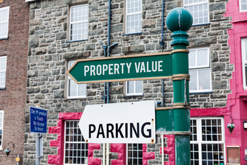 Fototapeta premium Conceptual hand writing showing Property Value. Concept meaning Worth of a land Real estate appraisal Fair market price Advertisement concept with empty copy space on the road sign