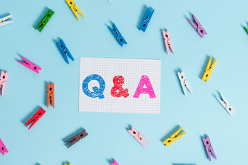 Handwriting text writing Q And A. Conceptual photo defined as questions being asked and answers Colored clothespin rectangle shaped reminder paper light blue background