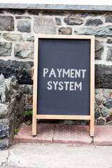 Handwriting text writing Payment System. Conceptual photo Compensation Scheme Method used in paying goods and services Empty black board with copy space for advertising. Blank dark board