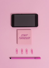 Text sign showing Staff Turnover. Business photo showcasing The percentage of workers that replaced by new employees Colored blank sticky note clips smartphone pen trendy pastel background