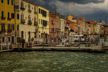 VENICE, ITALY - JULY,5: Stormy day in the center of Venice, boats, buildings, bridges under the heavy clouds