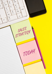 Conceptual hand writing showing Sales Strategy. Concept meaning Plan for reaching and selling to your target market Marketing Empty papers with copy space on yellow background table