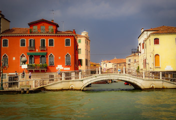 VENICE, ITALY - JULY,5: Stormy day in the center of Venice, boats, buildings, bridges under the heavy clouds