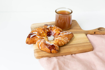 Strawberry and Sweet Cheese Danish with Icing Drizzle on Wooden Serving Board with Hot Coffee, Fruit Pastry Flat Lay