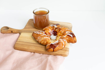 Strawberry and Sweet Cheese Danish with Icing Drizzle on Wooden Serving Board with Hot Coffee, Fruit Pastry Flat Lay