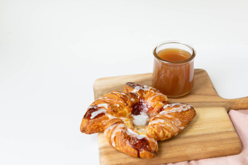 Strawberry and Sweet Cheese Danish with Icing Drizzle on Wooden Serving Board with Hot Coffee, Fruit Pastry Flat Lay
