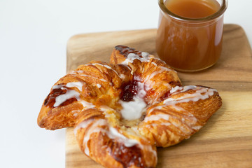 Strawberry and Sweet Cheese Danish with Icing Drizzle on Wooden Serving Board with Hot Coffee, Fruit Pastry Flat Lay