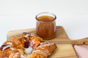Strawberry and Sweet Cheese Danish with Icing Drizzle on Wooden Serving Board with Hot Coffee, Fruit Pastry Flat Lay