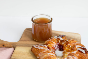 Strawberry and Sweet Cheese Danish with Icing Drizzle on Wooden Serving Board with Hot Coffee, Fruit Pastry Flat Lay