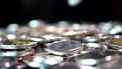 Slow motion close up falling coin on black background (Thai currency, THB coin)