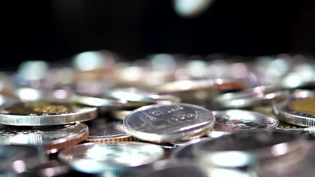Slow motion close up falling coin on black background (Thai currency, THB coin)